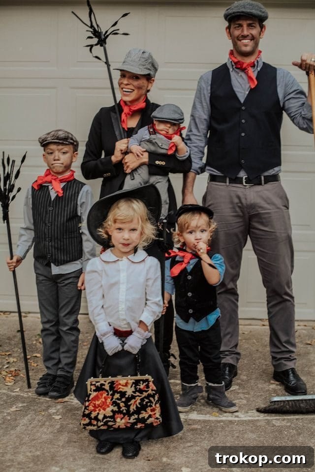 40 Spooktacular Family Halloween Costume Ideas 26 A family dressed in delightful Mary Poppins and chimney sweep Halloween costumes, capturing the classic film's charm.