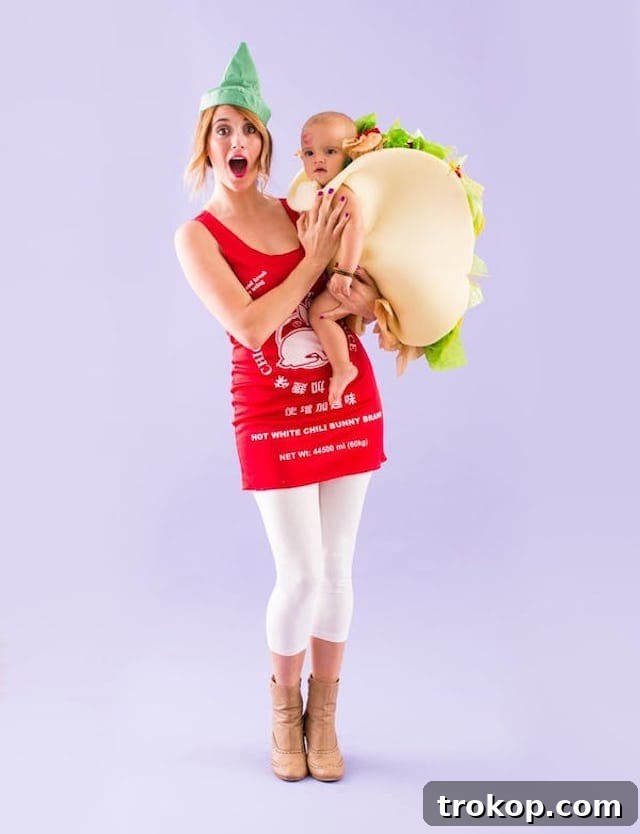 40 Spooktacular Family Halloween Costume Ideas 29 A mother dressed as a spicy Sriracha bottle, holding her baby dressed in an adorable taco costume.