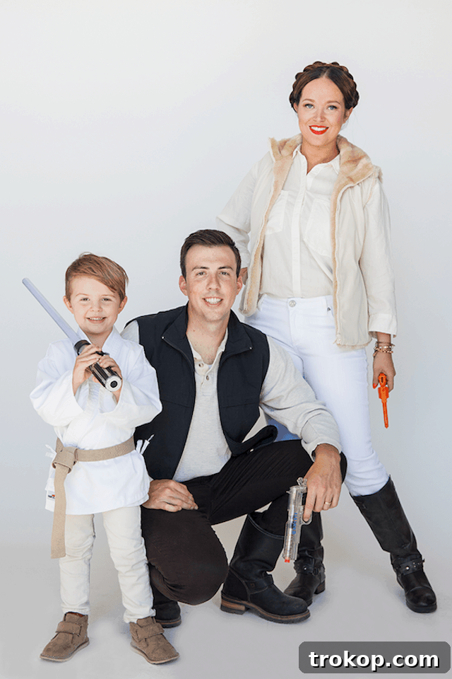 40 Spooktacular Family Halloween Costume Ideas 30 A family dressed as beloved Star Wars characters for Halloween, including Darth Vader, Princess Leia, and a Stormtrooper.