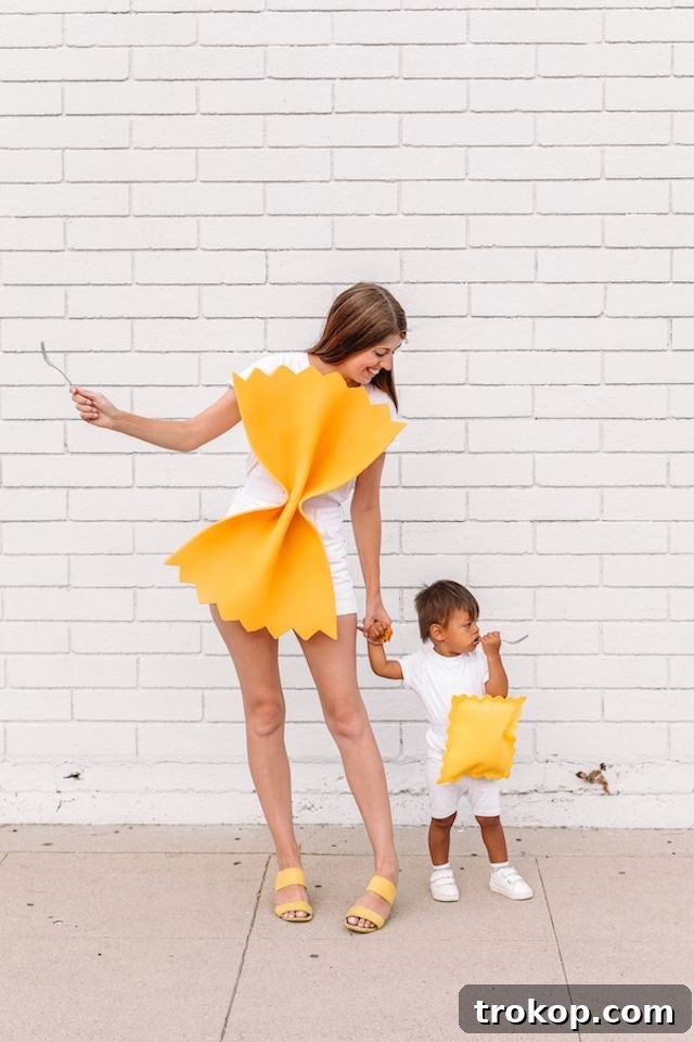 40 Spooktacular Family Halloween Costume Ideas 4 A mother and baby dressed in charming DIY pasta-themed Halloween costumes, celebrating their love for food.