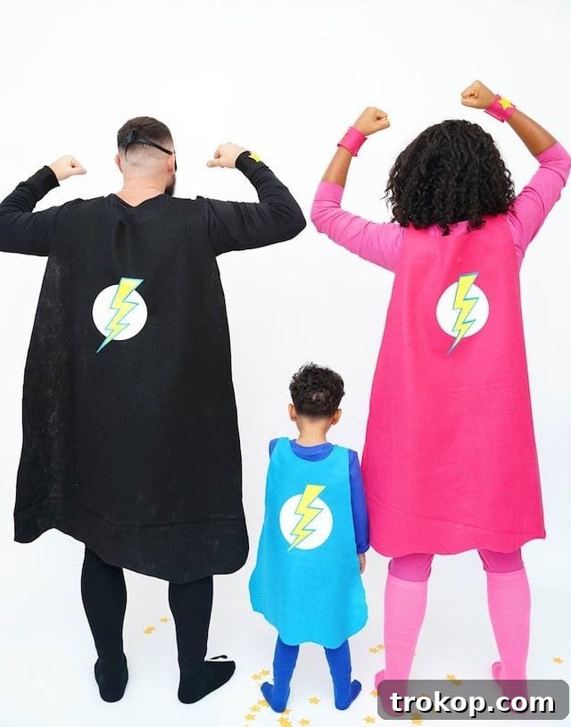 40 Spooktacular Family Halloween Costume Ideas 33 Parents and child dressed in unique DIY superhero Halloween costumes, showcasing personalized powers and symbols.