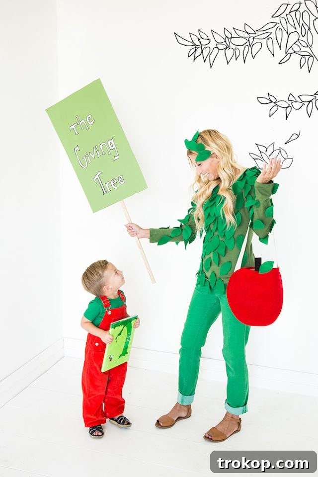 40 Spooktacular Family Halloween Costume Ideas 34 A mother and child in heartwarming DIY costumes based on Shel Silverstein's book 'The Giving Tree,' with the mother as the tree and child as the boy.