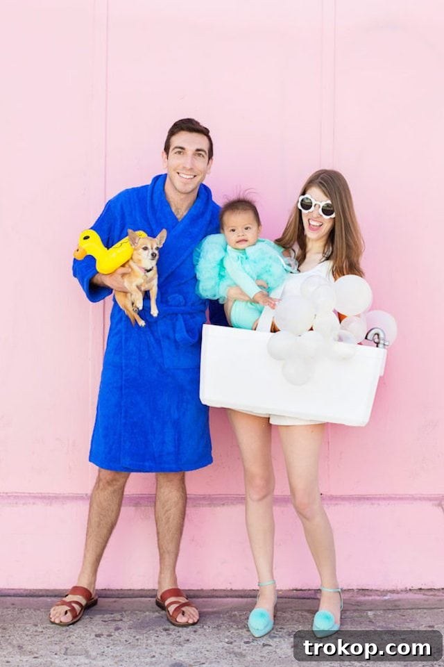 40 Spooktacular Family Halloween Costume Ideas 36 A family, including their dog, in whimsical DIY bath time Halloween costumes: bubble bath, loofah, person in robe, and rubber ducky.