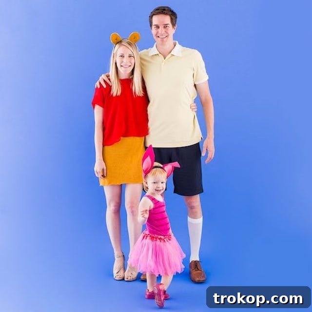 40 Spooktacular Family Halloween Costume Ideas 39 Parents and child dressed as Winnie the Pooh, Christopher Robin, and Piglet for a sweet family Halloween costume.