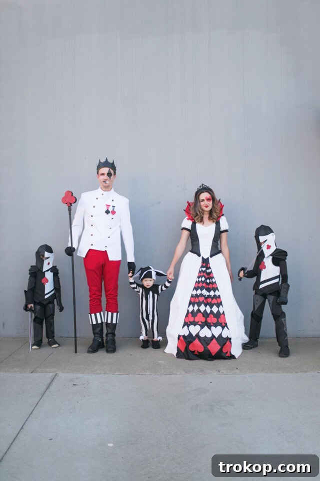 40 Spooktacular Family Halloween Costume Ideas 42 A family dressed in a royal Queen of Hearts and Deck of Cards themed Halloween costume.