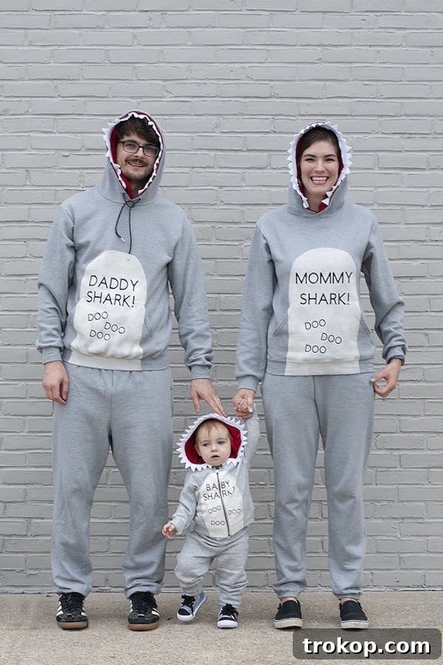 40 Spooktacular Family Halloween Costume Ideas 10 A family joyfully dressed in DIY Baby Shark Halloween costumes, featuring different colored sharks for each member.