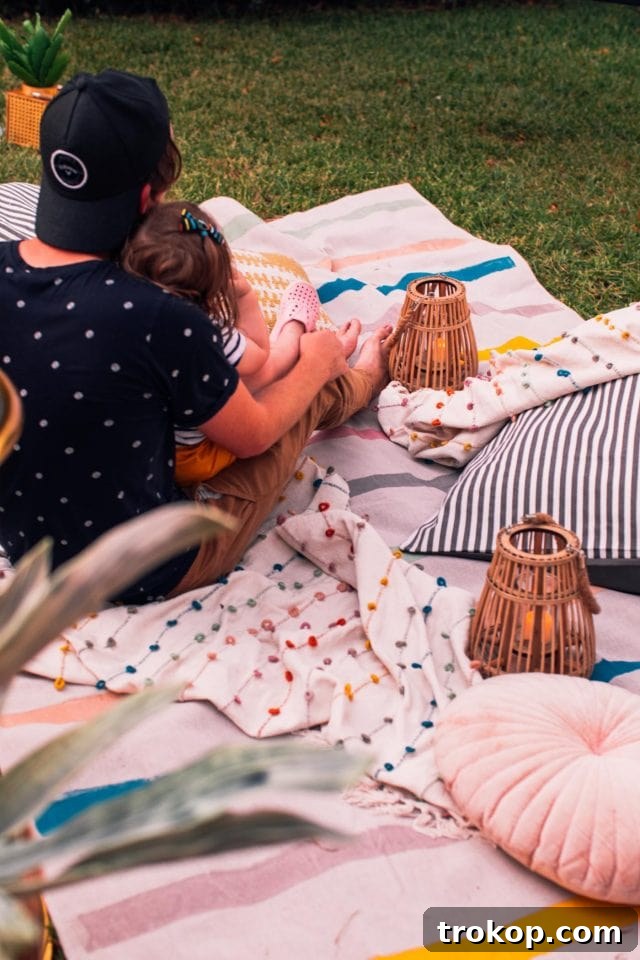 Crafting the Perfect Outdoor Movie Night Experience 12 Cozy outdoor movie night setup with blankets, pillows, and decorative lanterns