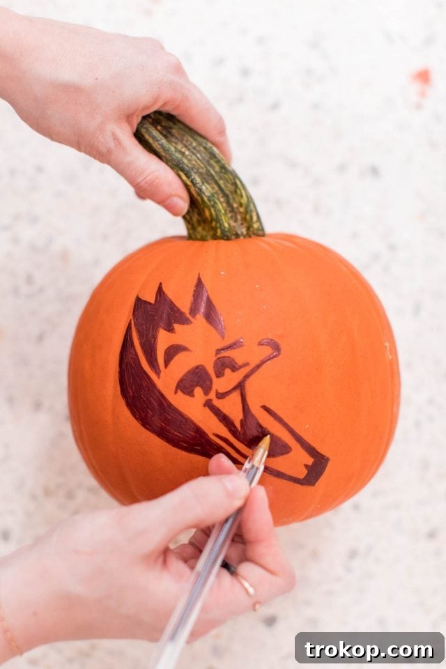 Tracing over the stencil lines with a pen