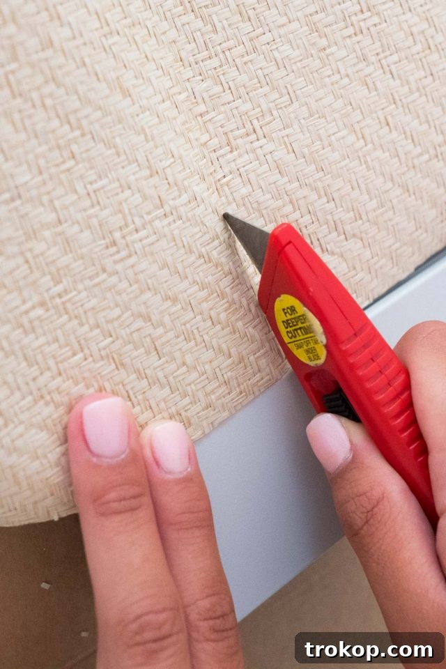 Cutting woven grasscloth for IKEA TV stand hack