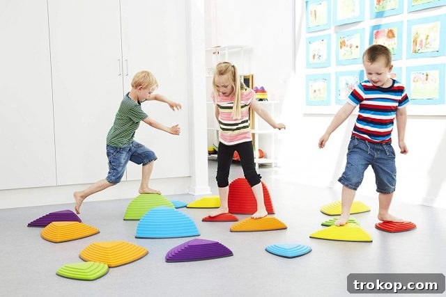 48 Irresistible Toys That Kids Will Love 14 Kids playing on Gonge Riverstones, promoting balance and coordination.