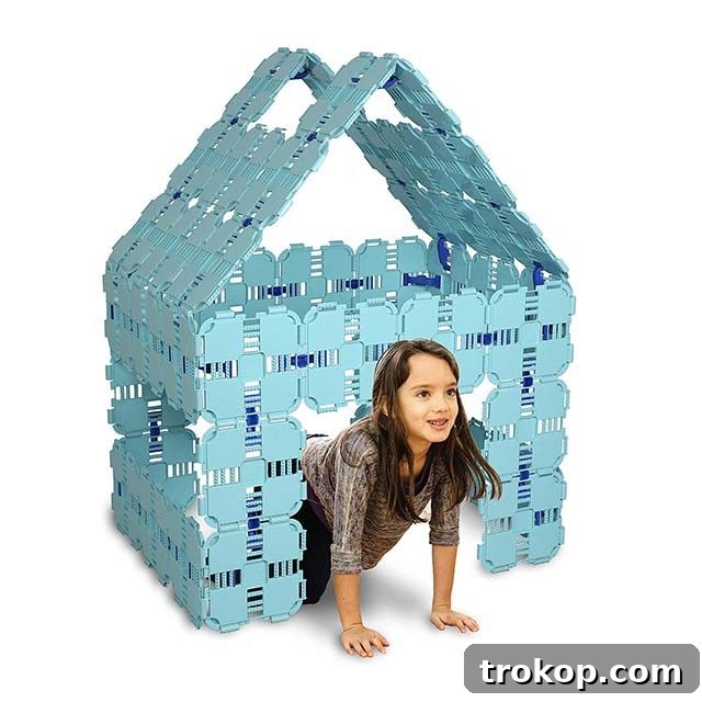 48 Irresistible Toys That Kids Will Love 34 Young girl playing in a collapsible modular fort kit, encouraging construction and imagination.