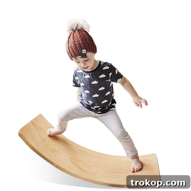 48 Irresistible Toys That Kids Will Love 7 Young boy playing on a wooden wobble balance board, promoting balance and creative play.