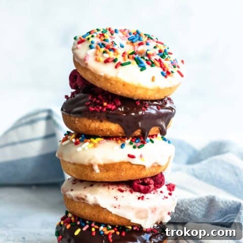 A stack of delicious baked gluten-free donuts, perfectly golden and ready for glazing, by top Houston lifestyle blogger Ashley Rose of Sugar & Cloth.