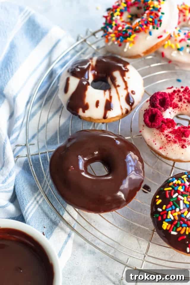 A delightful side view of perfectly baked gluten-free donuts, highlighting their fluffy texture and enticing glaze, by top Houston lifestyle blogger Ashley Rose of Sugar & Cloth.