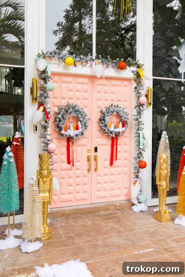 Vibrant Holiday Welcome: Christmas Doorway Designs 13 Side angle view of a pink door with Christmas decor