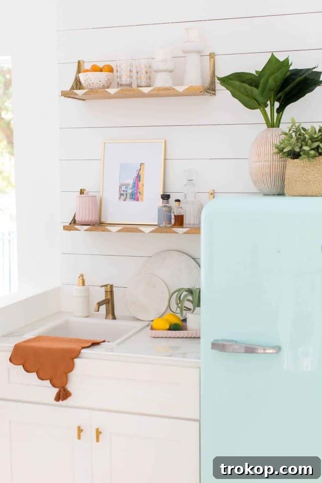Retro mint green fridge integrated into the wet bar, providing ample storage