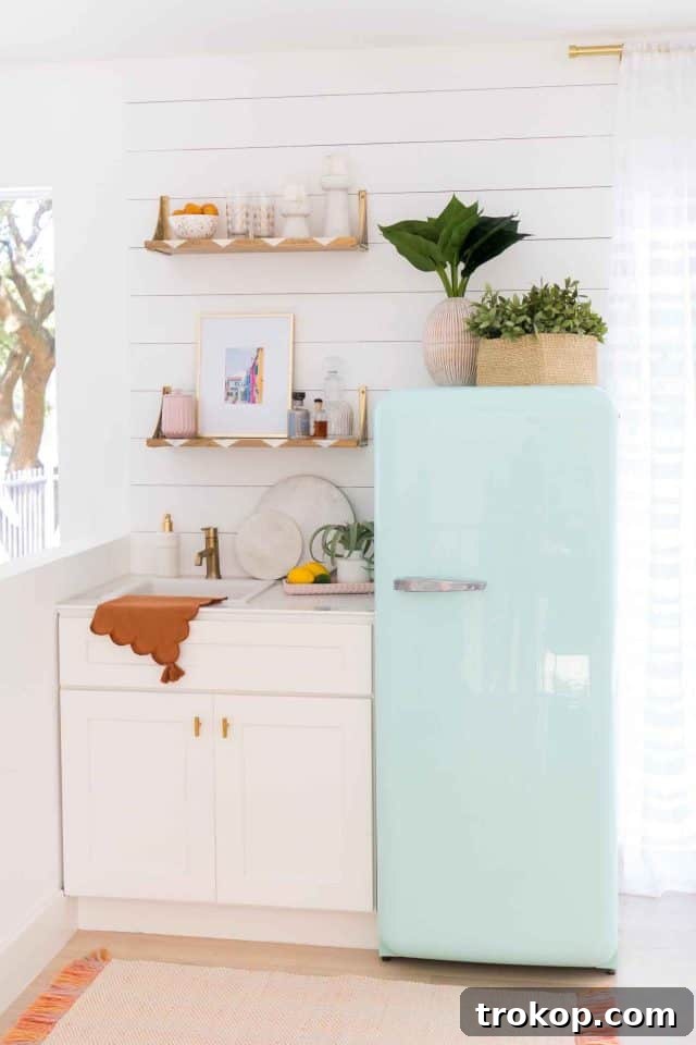 Stylish wet bar corner featuring open shelving, a sink, and decorative items