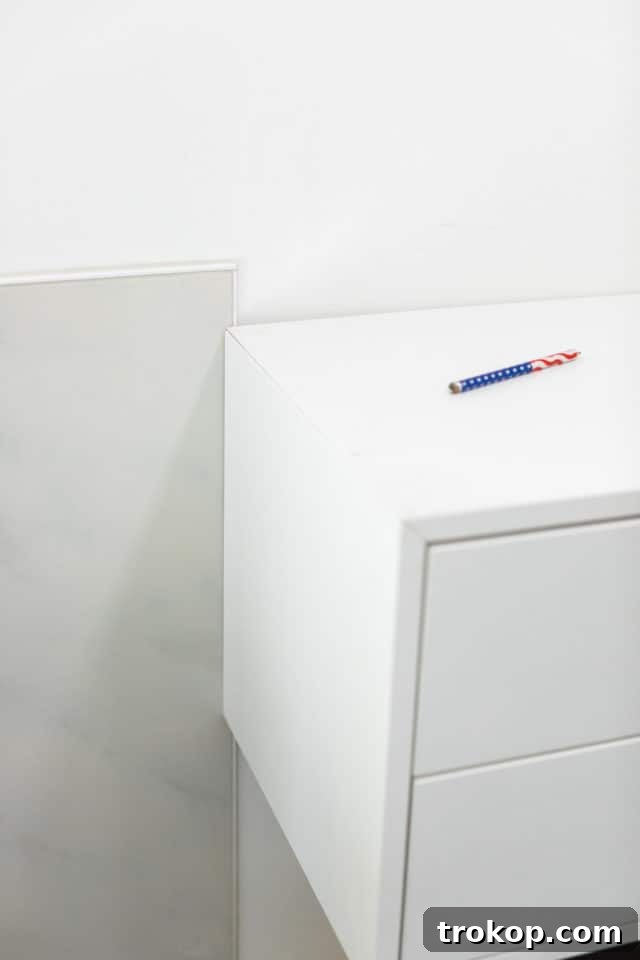 The IKEA Eket cabinets securely mounted to the wall using suspension rails, forming the base of the floating vanity.