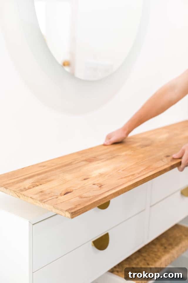 The finished wooden tabletop securely fastened to the IKEA cabinets, demonstrating the solid construction of the DIY vanity.