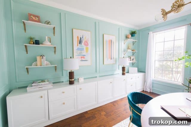 Unveiling Our Dream Home Office Design 16 A custom-built look storage wall in a home office, featuring IKEA Besta cabinets and decorative shelves.