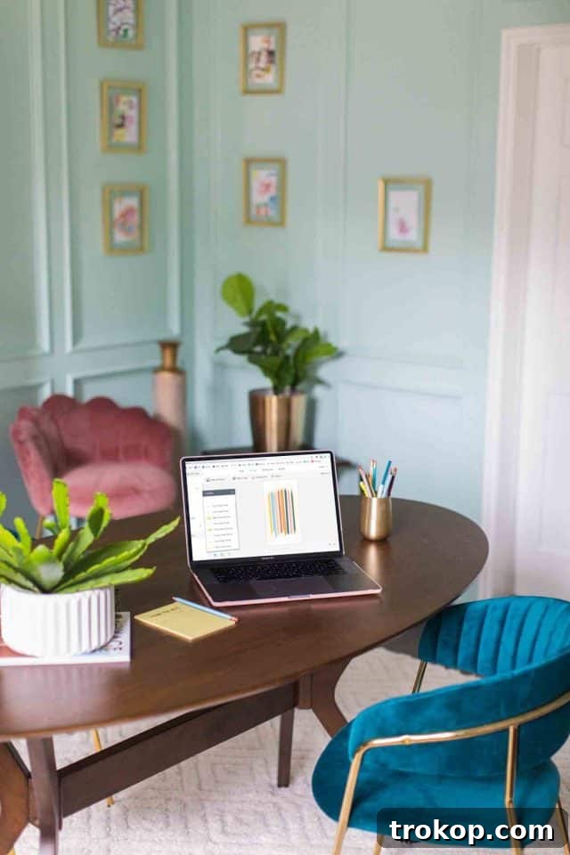 Unveiling Our Dream Home Office Design 8 A modern home office with a central desk, vibrant seating, and custom wall art, showcasing the finished design.