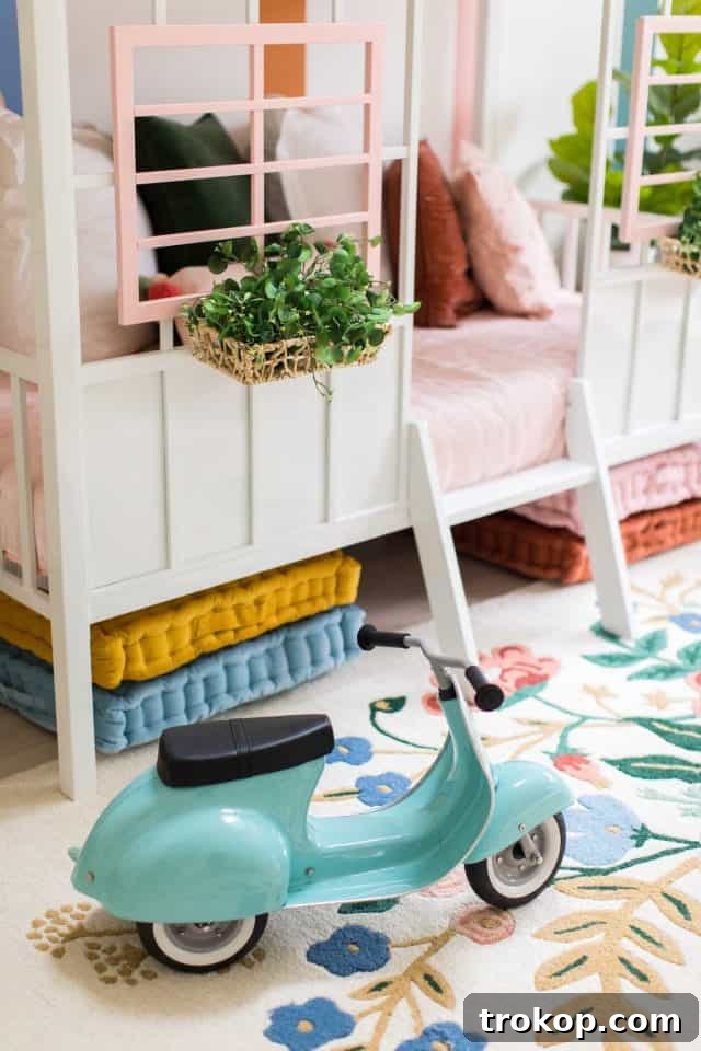 Vibrant Little Girls Room Makeover 3 Close-up of the toddler bedroom with a colorful striped wall and cozy seating area.