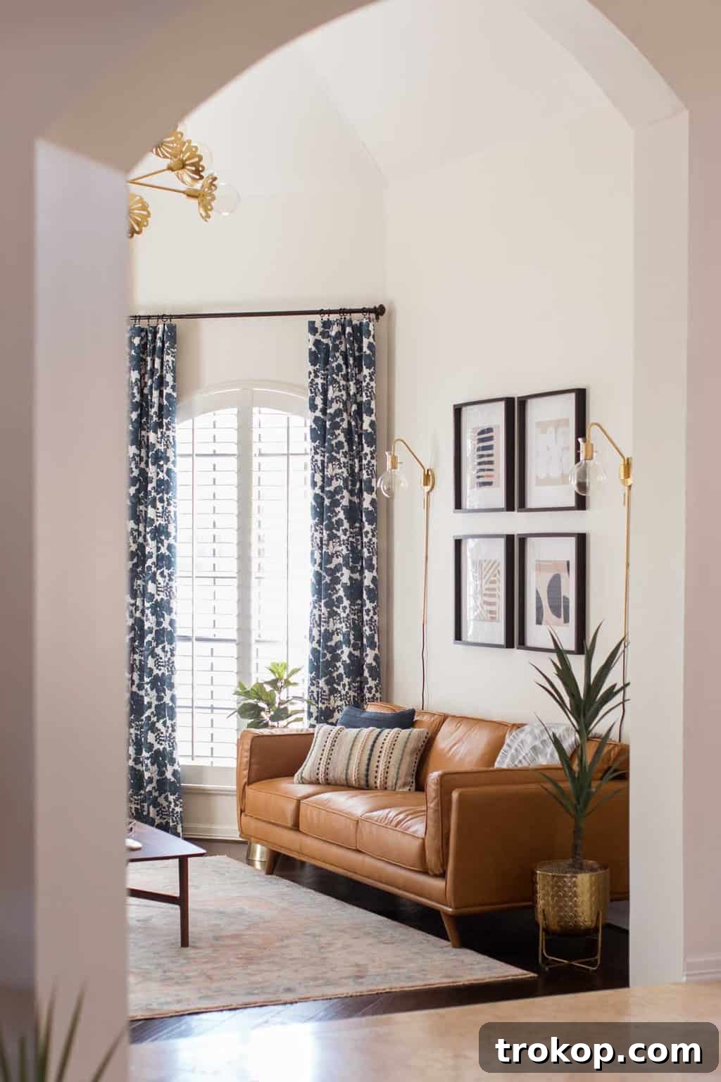 A Transitional Living Room's Stunning Style Transformation 14 Design tip photo illustrating how to add height to a living room, focusing on curtain placement and vertical elements.