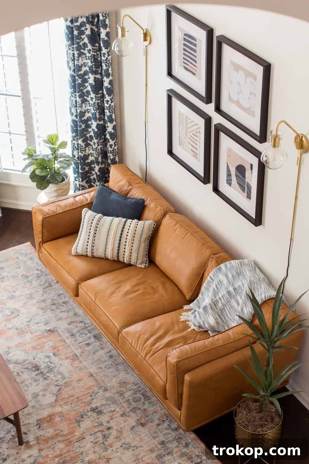 A Transitional Living Room's Stunning Style Transformation 16 Photo highlighting the new statement chandelier and sconces, illuminating the transformed transitional living room with modern light.