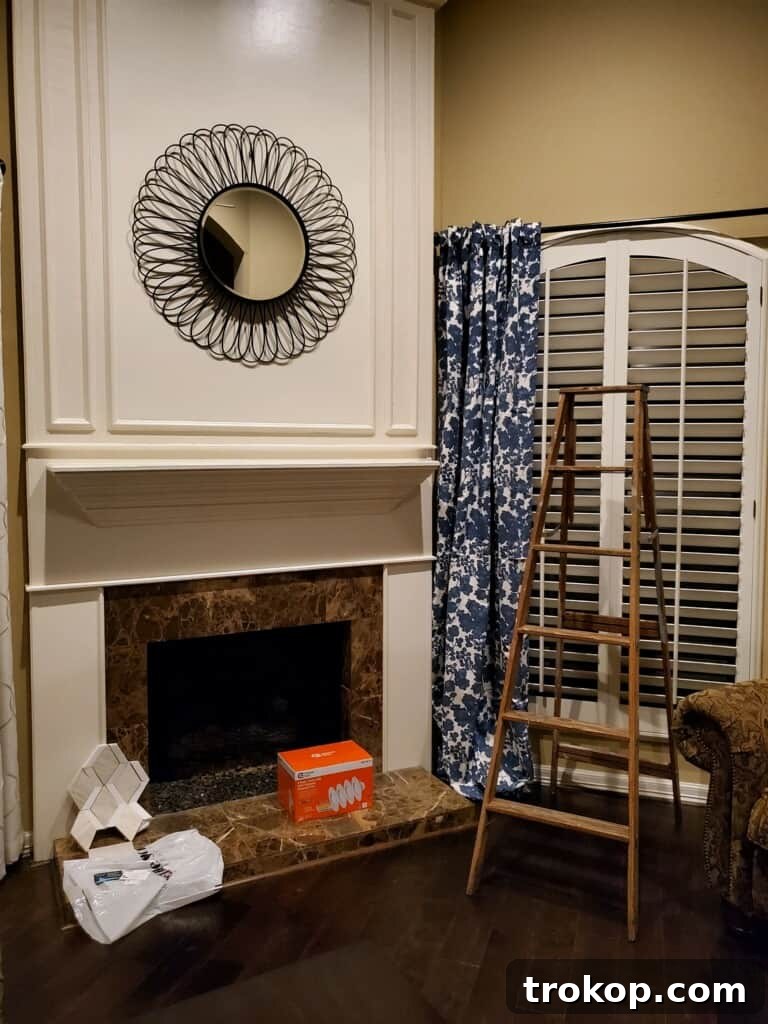 A Transitional Living Room's Stunning Style Transformation 5 Before photo of the outdated living room fireplace, showing its traditional and heavy appearance.