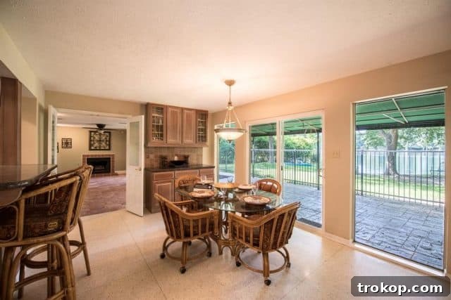 Before renovation: dark living room with tile floor and small fireplace
