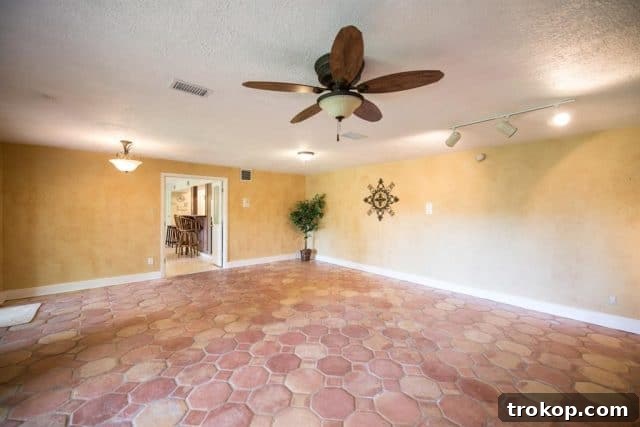 Before renovation: fireplace wall with old lighting and dated tile