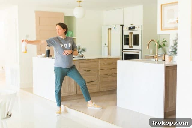 photo of my husband trying to clean while wearing a fake pregnant belly, reaching for something