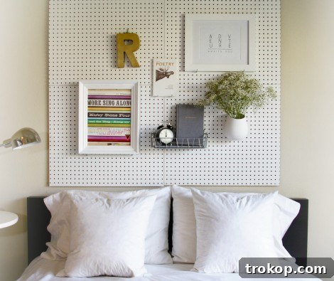 Close-up of DIY pegboard headboard with organized items