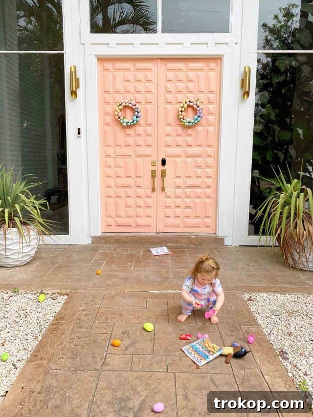 Girl holding a basket of Easter eggs on a front porch