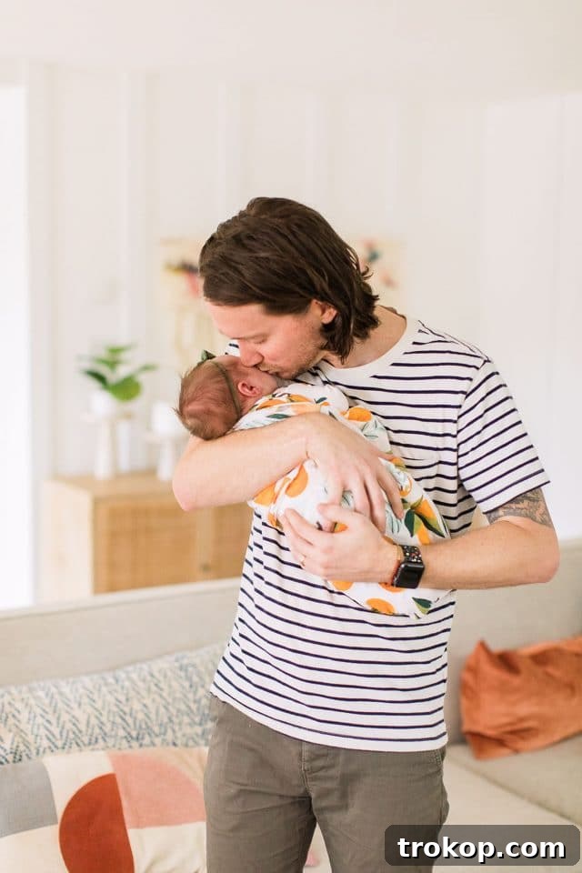 Luca's Newborn Journey: Our Favorite Captures 18 Proud dad holding his newborn daughter Luca with love