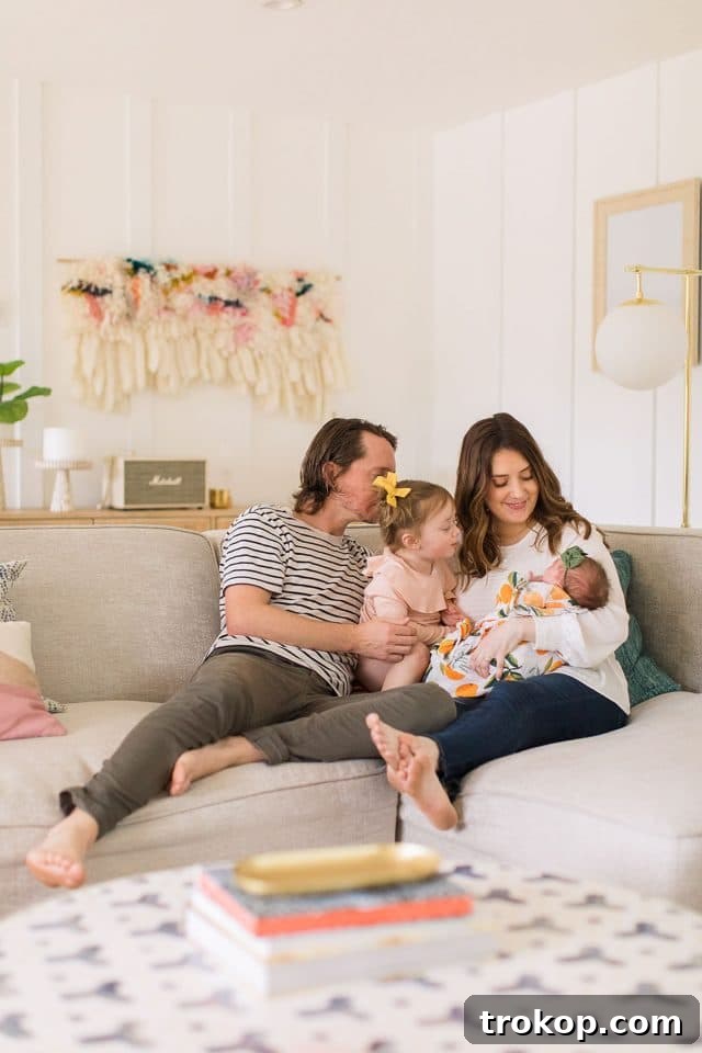 Luca's Newborn Journey: Our Favorite Captures 19 Cozy newborn family photo in the living room, featuring parents, Gwen, and Luca