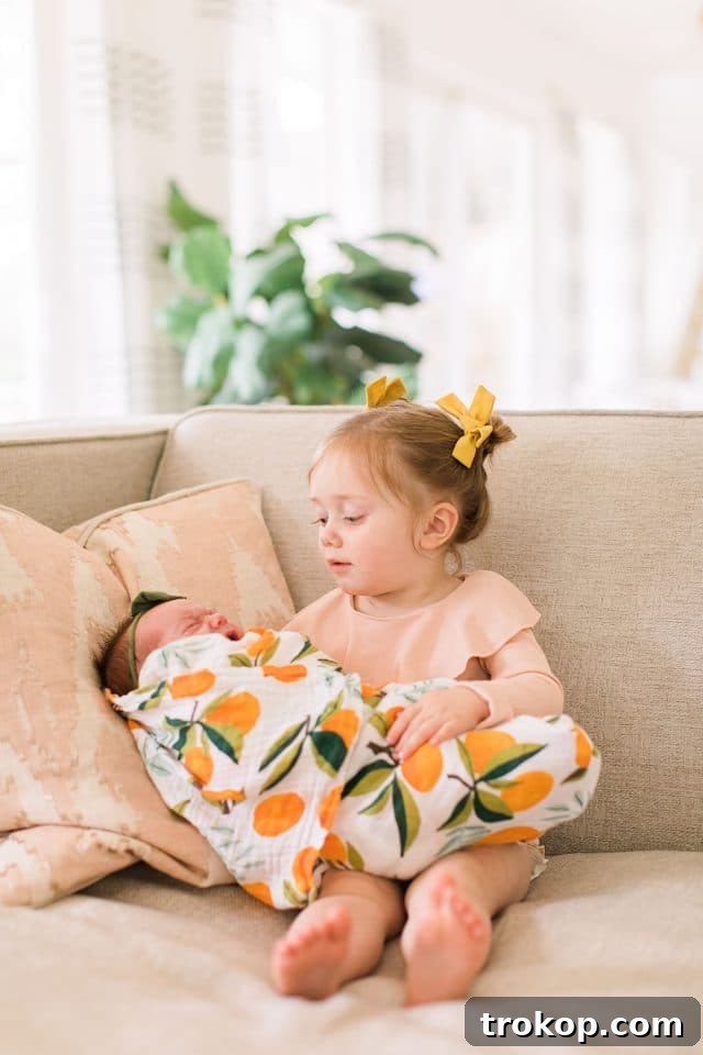 Luca's Newborn Journey: Our Favorite Captures 22 Toddler Gwen sweetly interacting with her baby sister Luca during the newborn photo shoot