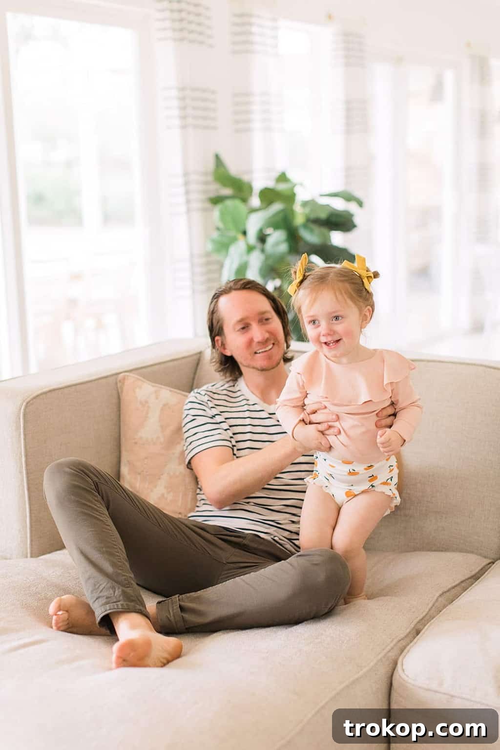 Luca's Newborn Journey: Our Favorite Captures 4 Dad and daughter Gwen sharing a joyful moment on the couch
