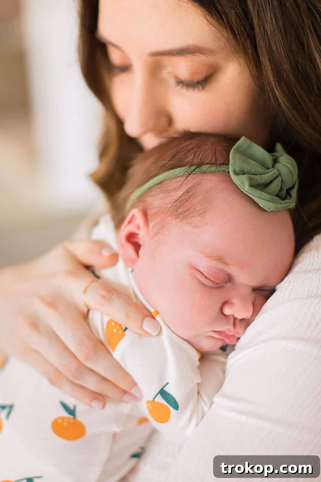 Luca's Newborn Journey: Our Favorite Captures 5 Close-up of newborn baby girl Luca peacefully sleeping with a delicate bow