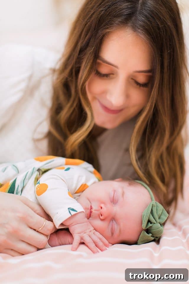 Luca's Newborn Journey: Our Favorite Captures 9 Mom tenderly holding newborn baby girl Luca, a moment of maternal love