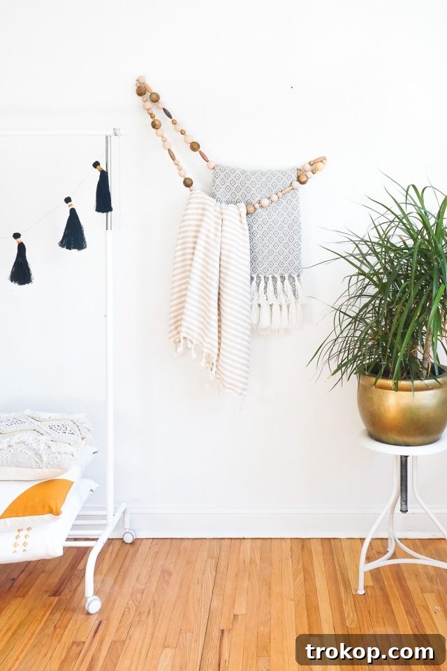 Functional and artistic DIY Minimal Beaded Blanket Holder, suitable for nurseries or living rooms, doubling as wall art.