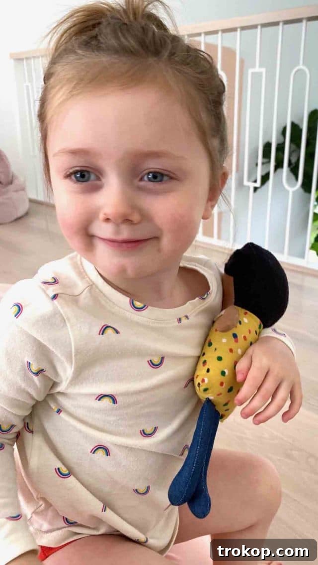 A young girl, Gwen, with a sweet smile, holding her favorite doll, reflecting her growing personality and the rapid pace of childhood.