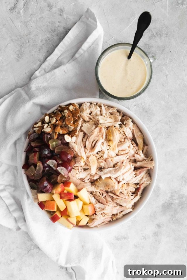 The Definitive Chicken Salad 3 All the fresh ingredients laid out, including grapes, apples, almonds, and the creamy dressing components, ready for the best chicken salad.