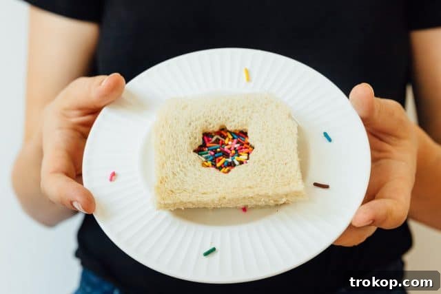 Whip Up Whimsical Fairy Bread 2 A close-up shot of an easy-to-make fairy bread sandwich, showcasing its colorful sprinkles and soft bread texture, ready to be enjoyed.