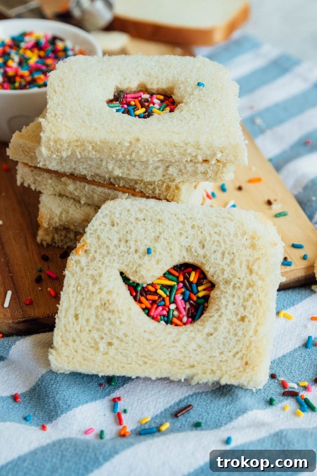My Favorite Fairy Bread Recipe A beautifully composed shot of a fairy bread sandwich, highlighting its inviting colors and delightful texture, prepared by Ashley Rose of Sugar & Cloth.
