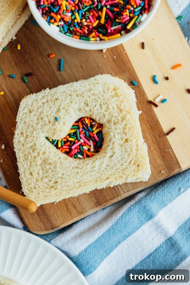 Whip Up Whimsical Fairy Bread 4 A finished rainbow-themed fairy bread sandwich, showing off the vibrant sprinkles and creative cutout, ready to be enjoyed.