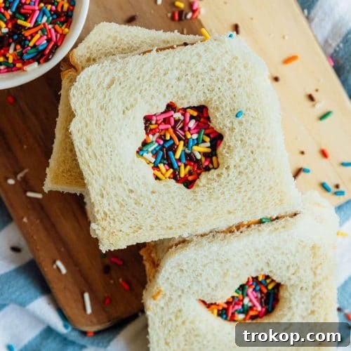 A collection of different cookie cutter shapes demonstrated on slices of bread, inspiring creative fairy bread designs.