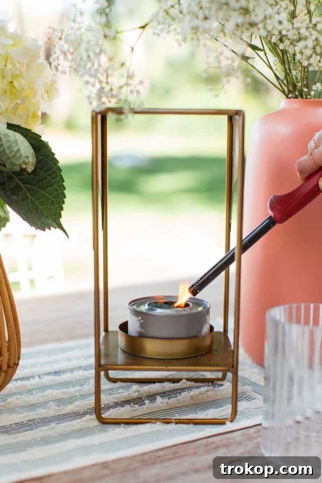 A close-up image of a person lighting a Sterno gel can with a stick lighter, showcasing the simple step for outdoor fly deterrence.