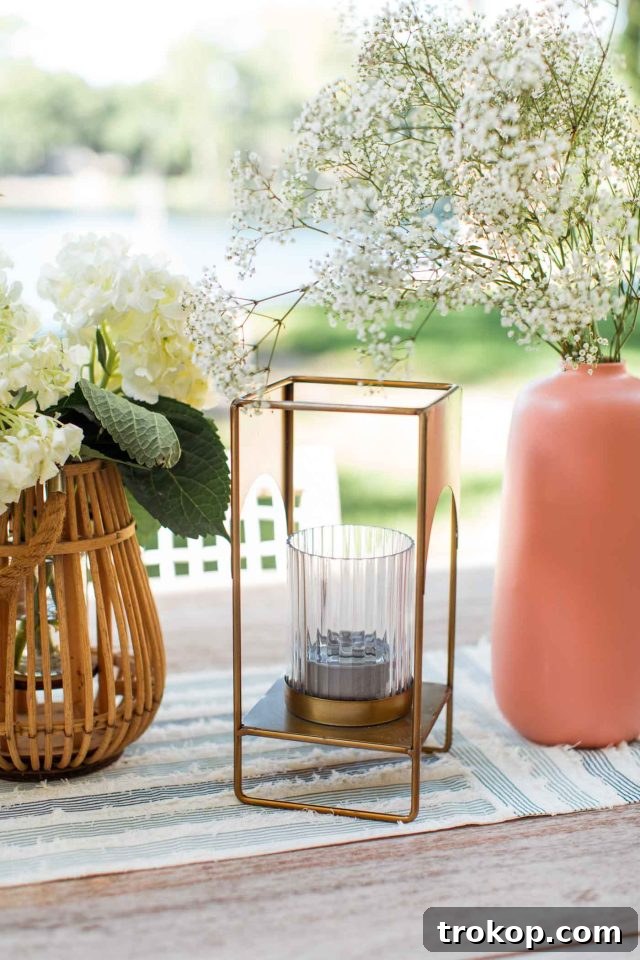 An elegant brass lantern sits on an outdoor table, subtly housing a Sterno can to deter flies during al fresco dining.