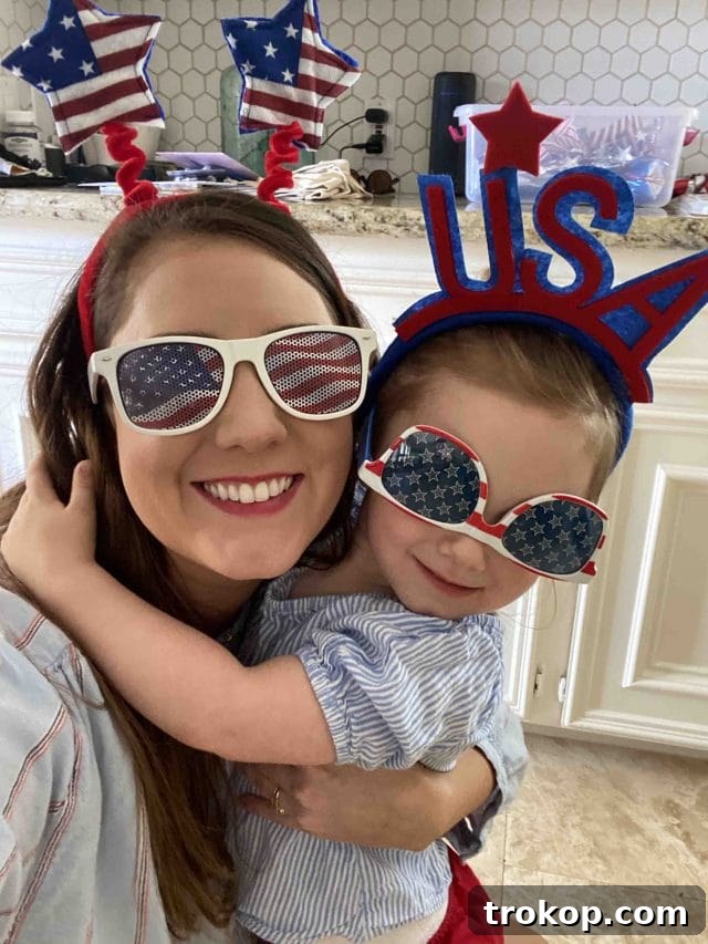 A heartwarming close-up photo of Ashley and her daughter Gwen, both elegantly dressed in matching 4th of July outfits, radiating joy and patriotism.